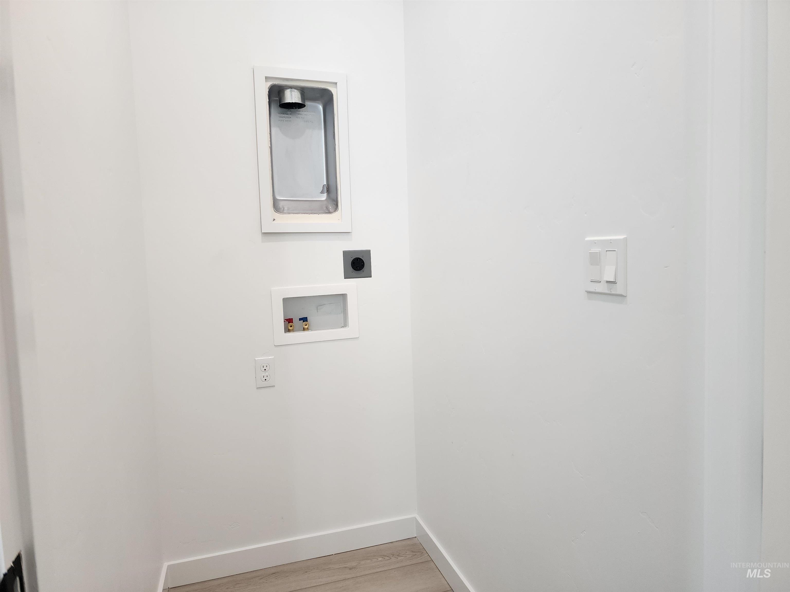 12267 West Endsley Street Star, ID 83669 - Photo 10 of 18 Laundry area featuring washer hookup, light wood-type flooring, and electric dryer hookup