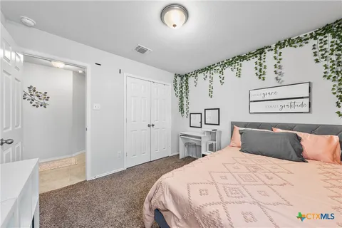a bedroom with a large bed and a couch