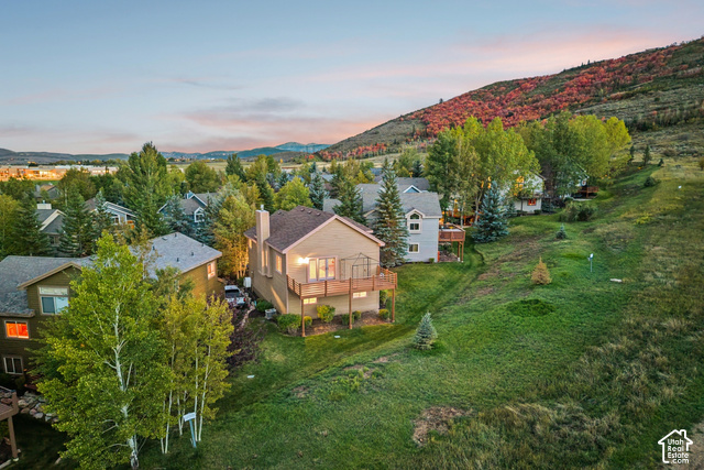 7396 Brook Hollow Loop Road Park City, UT 84098 - Photo 52 of 60 Terraced hillside property with mature trees, a multi-level deck, and a sloping green lawn