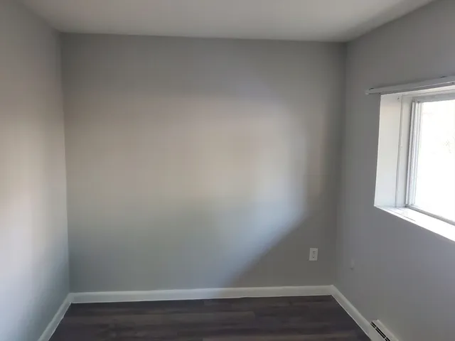 a view of an empty room and wooden floor