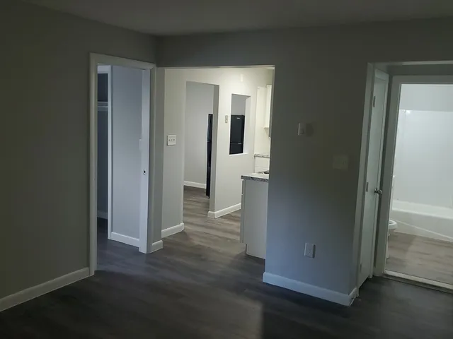 an empty room with wooden floor & closet