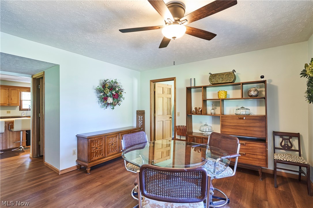 1121 Novak Road Grafton, OH 44044 - Photo 26 of 37 Dining area featuring a textured ceiling, dark hardwood / wood-style vinyl floors, and ceiling fan