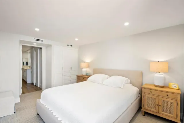 a bedroom with a bed and a night stand