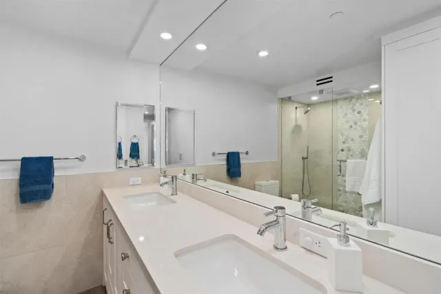 a bathroom with a double vanity sink mirror and double
