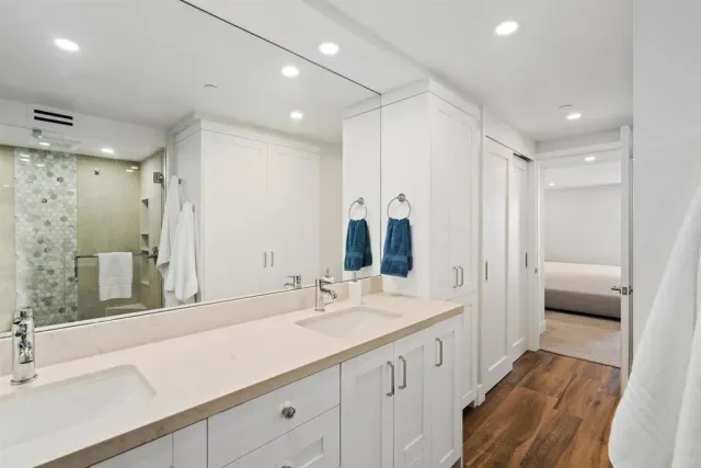 a bathroom with a double vanity sink a and a mirror