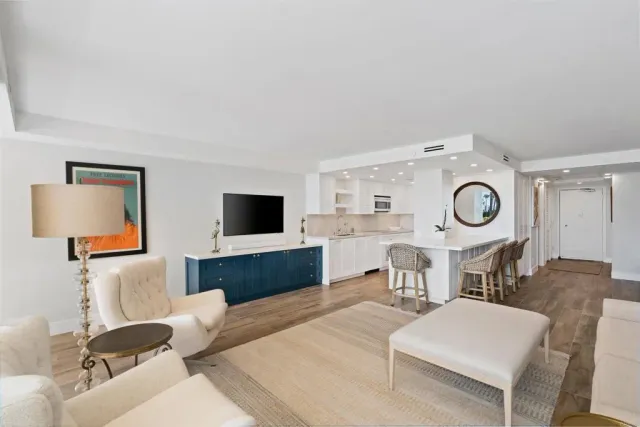 a living room with furniture a flat screen tv and rug