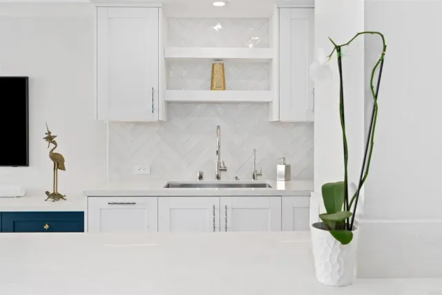 a kitchen with kitchen island a sink a counter top space and cabinets
