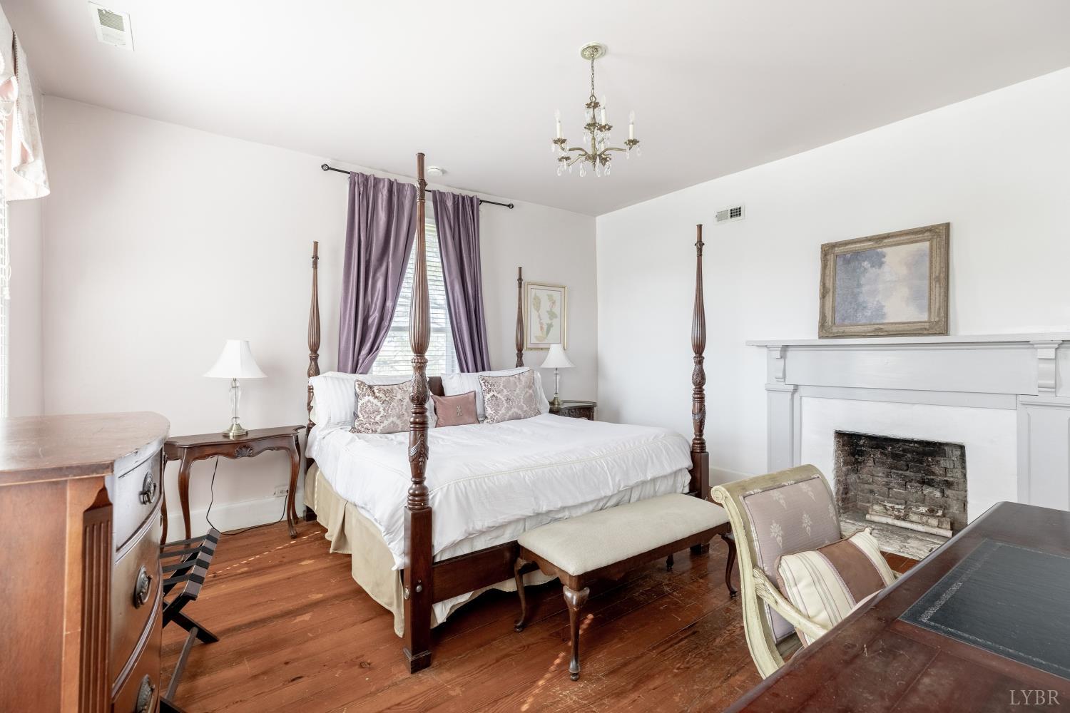 2416 Lowesville Road Amherst, VA 24521 - Photo 27 of 82 a bedroom with a bed and a fireplace