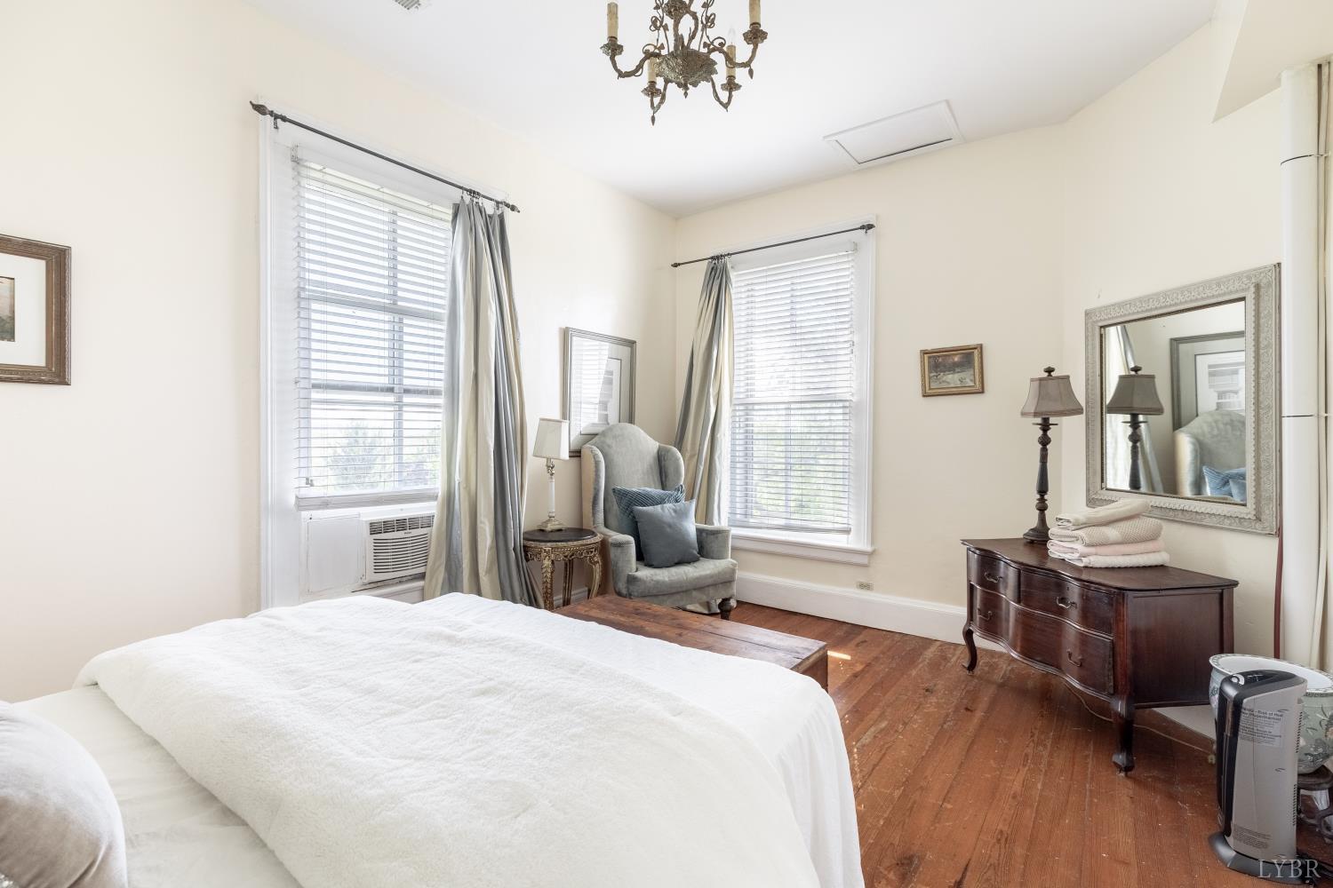 2416 Lowesville Road Amherst, VA 24521 - Photo 35 of 82 a bedroom with a large bed and wooden floor