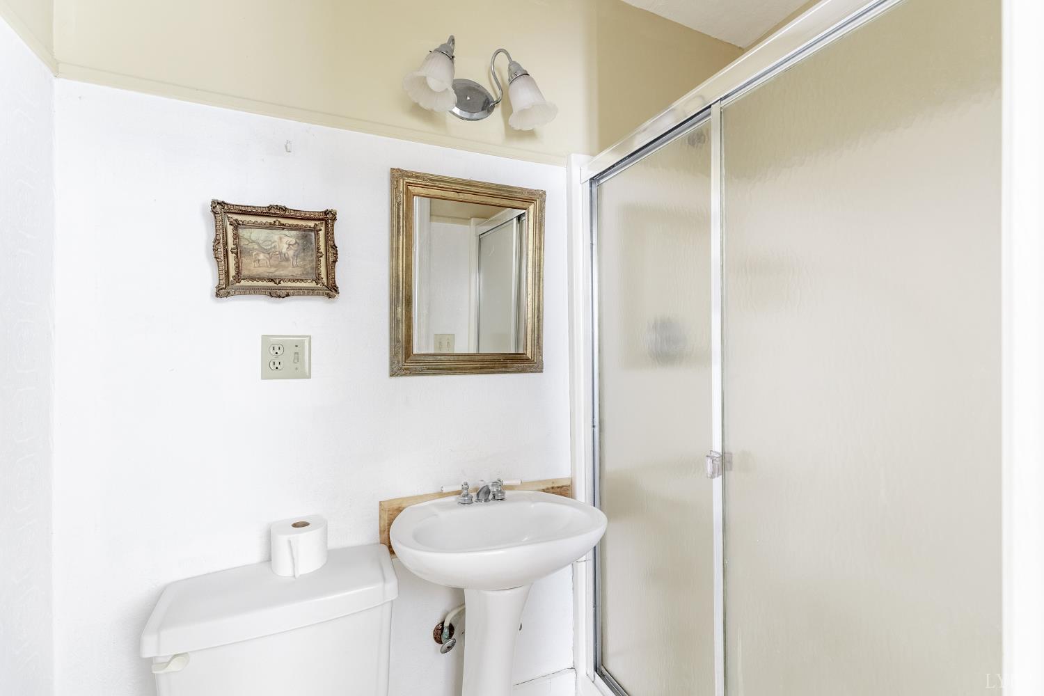 2416 Lowesville Road Amherst, VA 24521 - Photo 38 of 82 a bathroom with a sink and mirror with toilet