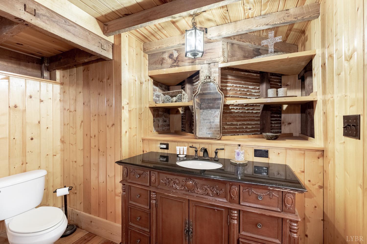 2416 Lowesville Road Amherst, VA 24521 - Photo 54 of 82 a bathroom with a granite countertop sink a toilet and shower