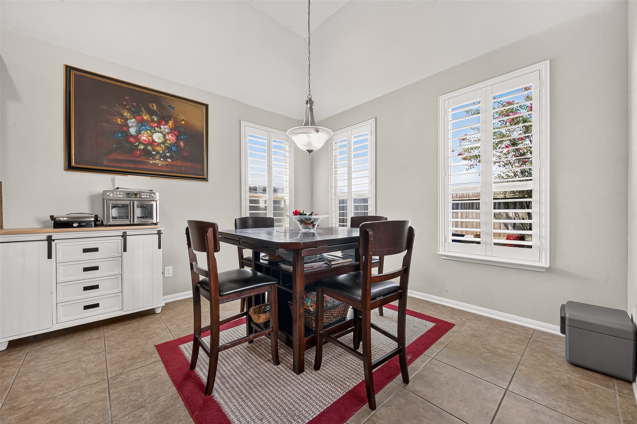 4910 Culver Lane Rosenberg, TX 77471 - Photo 30 of 50 Bright breakfast area with high ceilings, featuring large windows with plantation shutters. Tiled floor and hanging light fixture completes the warm, inviting space.