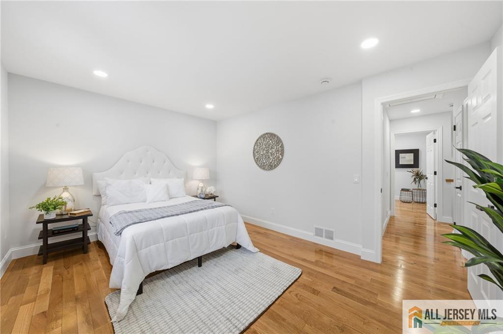 6 Wilton Avenue Middlesex, NJ 08846 - Photo 20 of 50 a bedroom with a bed and a chandelier