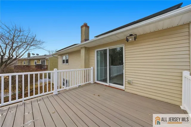 a view of a house with wooden deck