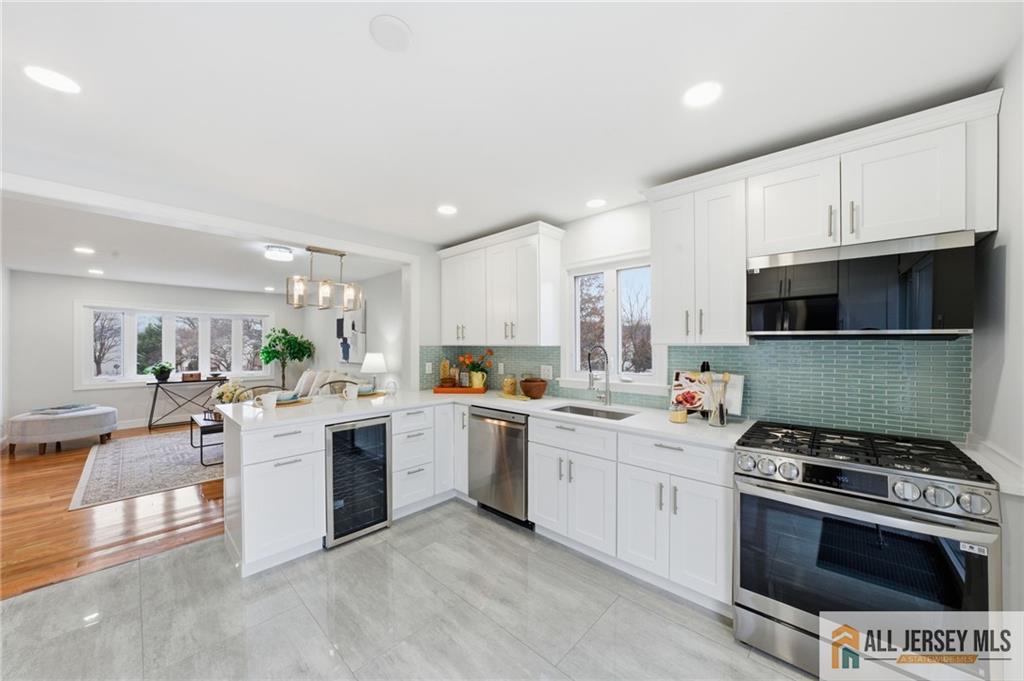 6 Wilton Avenue Middlesex, NJ 08846 - Photo 5 of 50 a kitchen with a stove and white cabinets