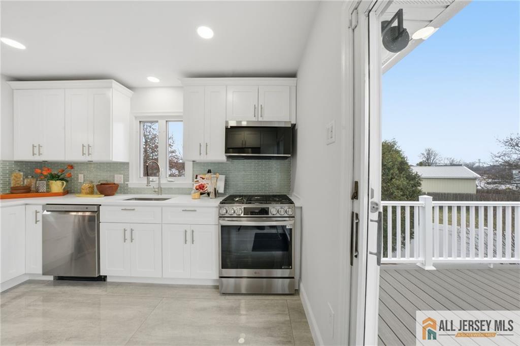 6 Wilton Avenue Middlesex, NJ 08846 - Photo 6 of 50 a kitchen with a stove a sink and a microwave