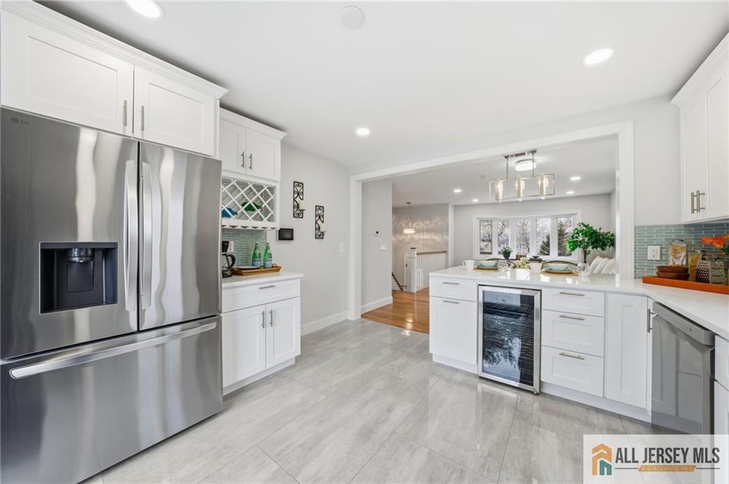 6 Wilton Avenue Middlesex, NJ 08846 - Photo 7 of 50 a kitchen with white cabinets and stainless steel appliances