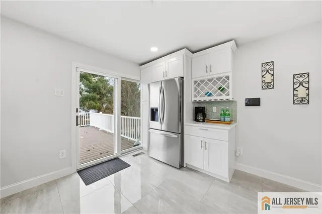 a kitchen with stainless steel appliances a refrigerator sink and microwave