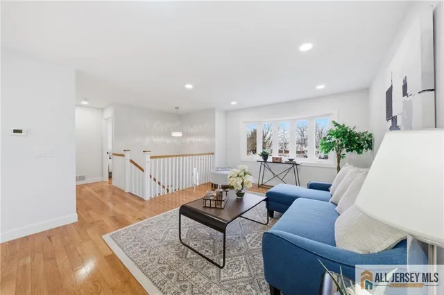 a living room with furniture rug and wooden floor