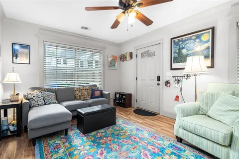 a living room with furniture and a baby crib
