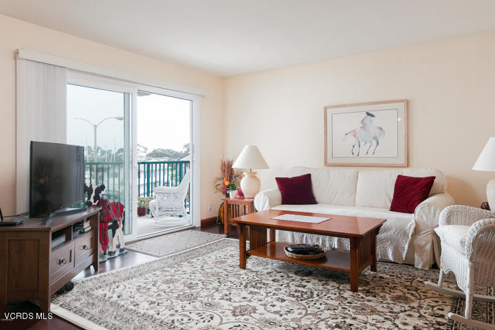 2901 Peninsula Road, Unit 237 Oxnard, CA 93035 - Photo 11 of 35 a living room with furniture a flat screen tv and a floor to ceiling window