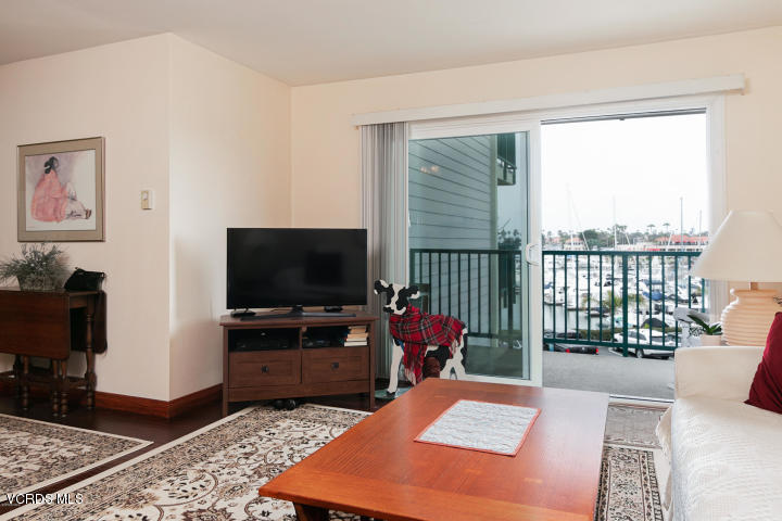 2901 Peninsula Road, Unit 237 Oxnard, CA 93035 - Photo 12 of 35 a living room with furniture and a flat screen tv
