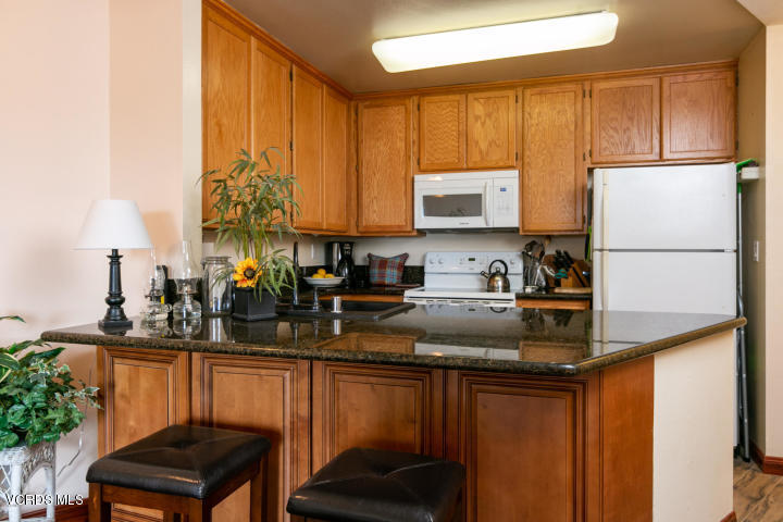 2901 Peninsula Road, Unit 237 Oxnard, CA 93035 - Photo 5 of 35 a kitchen with a refrigerator and a sink