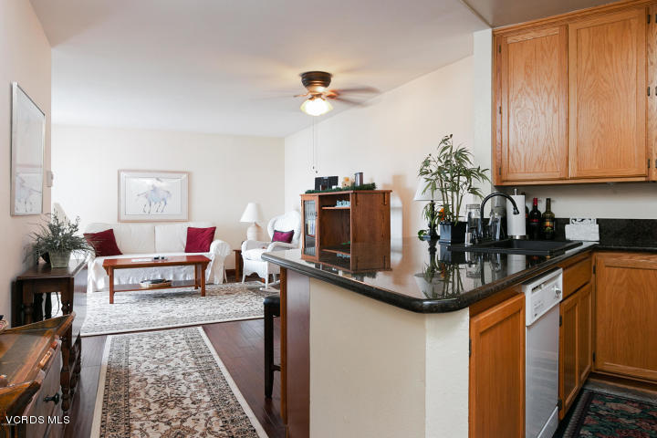 2901 Peninsula Road, Unit 237 Oxnard, CA 93035 - Photo 7 of 35 a kitchen with sink refrigerator and dining table