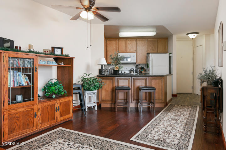 2901 Peninsula Road, Unit 237 Oxnard, CA 93035 - Photo 8 of 35 a dining room with wooden floor a chandelier a wooden table and chairs