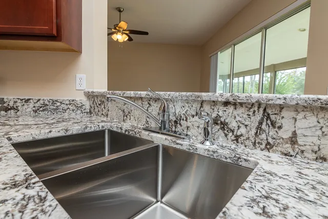 a kitchen with stainless steel appliances granite countertop a stove microwave and refrigerator