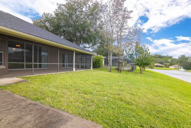 a view of a house with a backyard and a garden