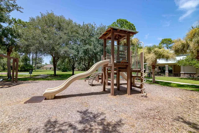 a view of outdoor space with playground and green space