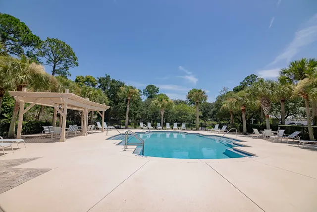 a swimming pool with outdoor seating and yard