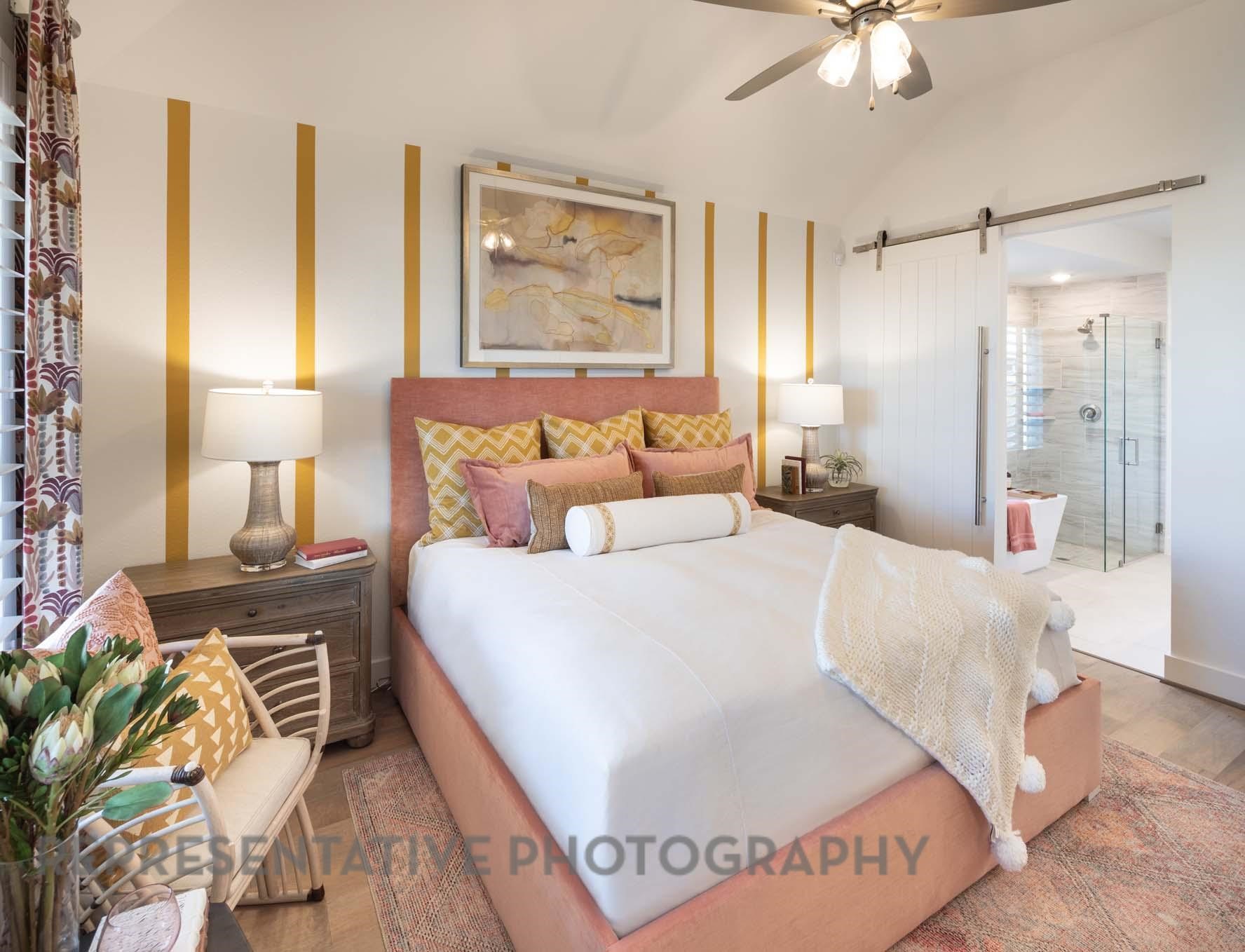5310 Getty Lane Manvel, TX 77578 - Photo 16 of 37 a bedroom with a large bed and a chandelier