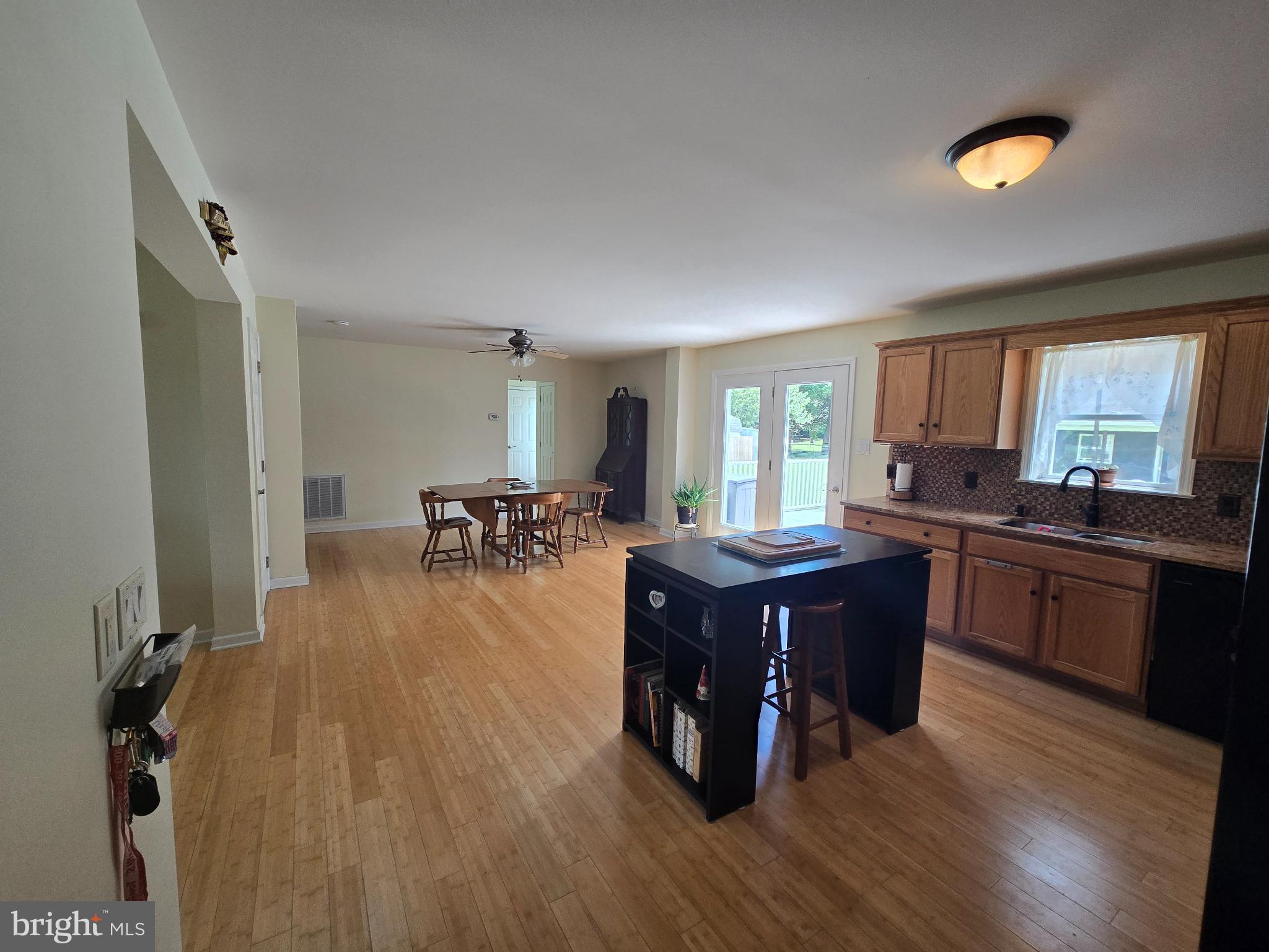 18453 Joseph Road Milton, DE 19968 - Photo 14 of 49 a kitchen with stainless steel appliances granite countertop a refrigerator a sink dishwasher a stove and white countertops with wooden floor