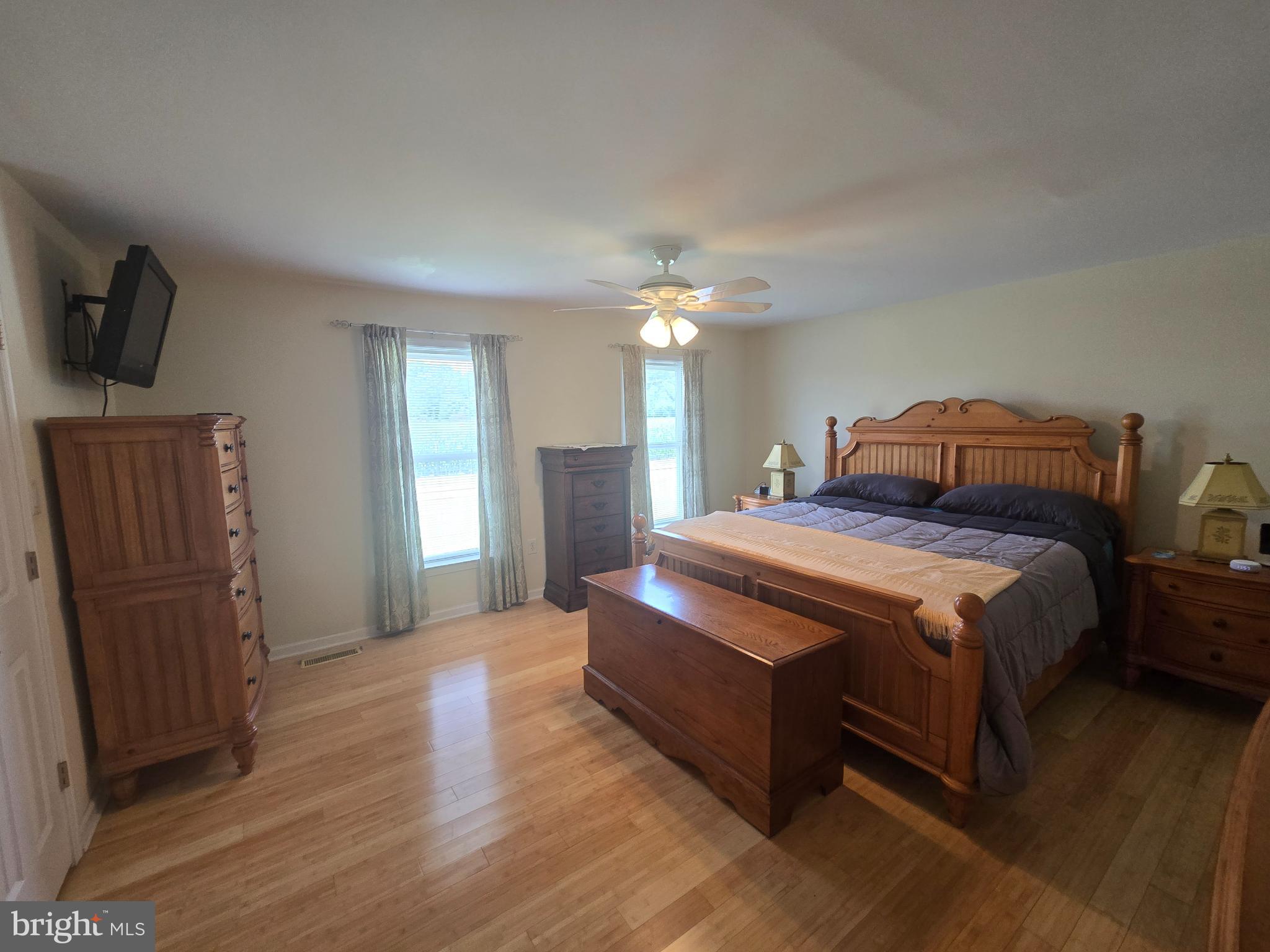 18453 Joseph Road Milton, DE 19968 - Photo 16 of 49 a spacious bedroom with a bed and wooden floor