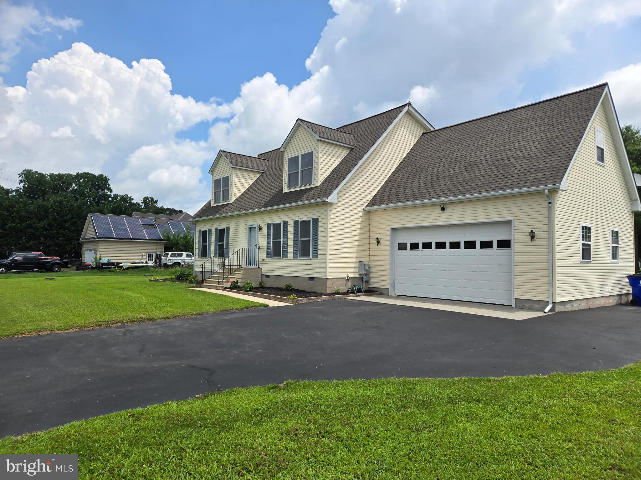 18453 Joseph Road Milton, DE 19968 - Photo 2 of 49 a view of a house with a yard and garage