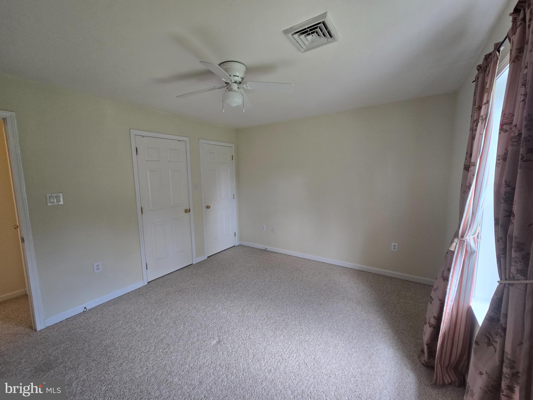 18453 Joseph Road Milton, DE 19968 - Photo 27 of 49 an empty room with a ceiling fan and window