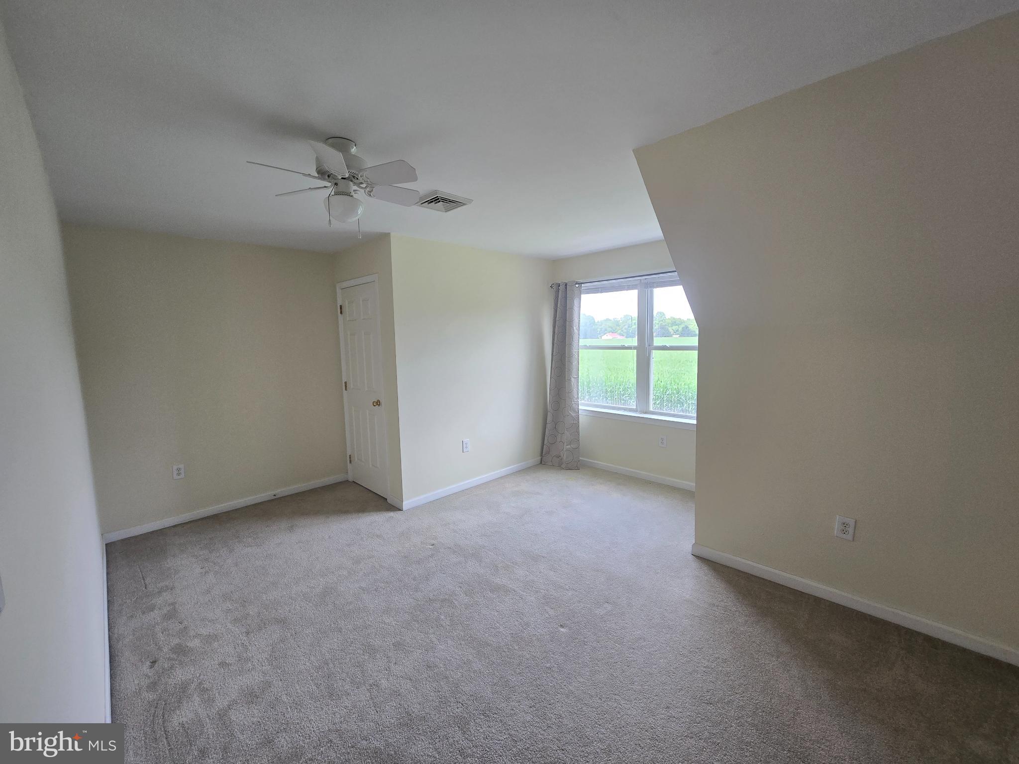 18453 Joseph Road Milton, DE 19968 - Photo 29 of 49 an empty room with a window and a ceiling fan