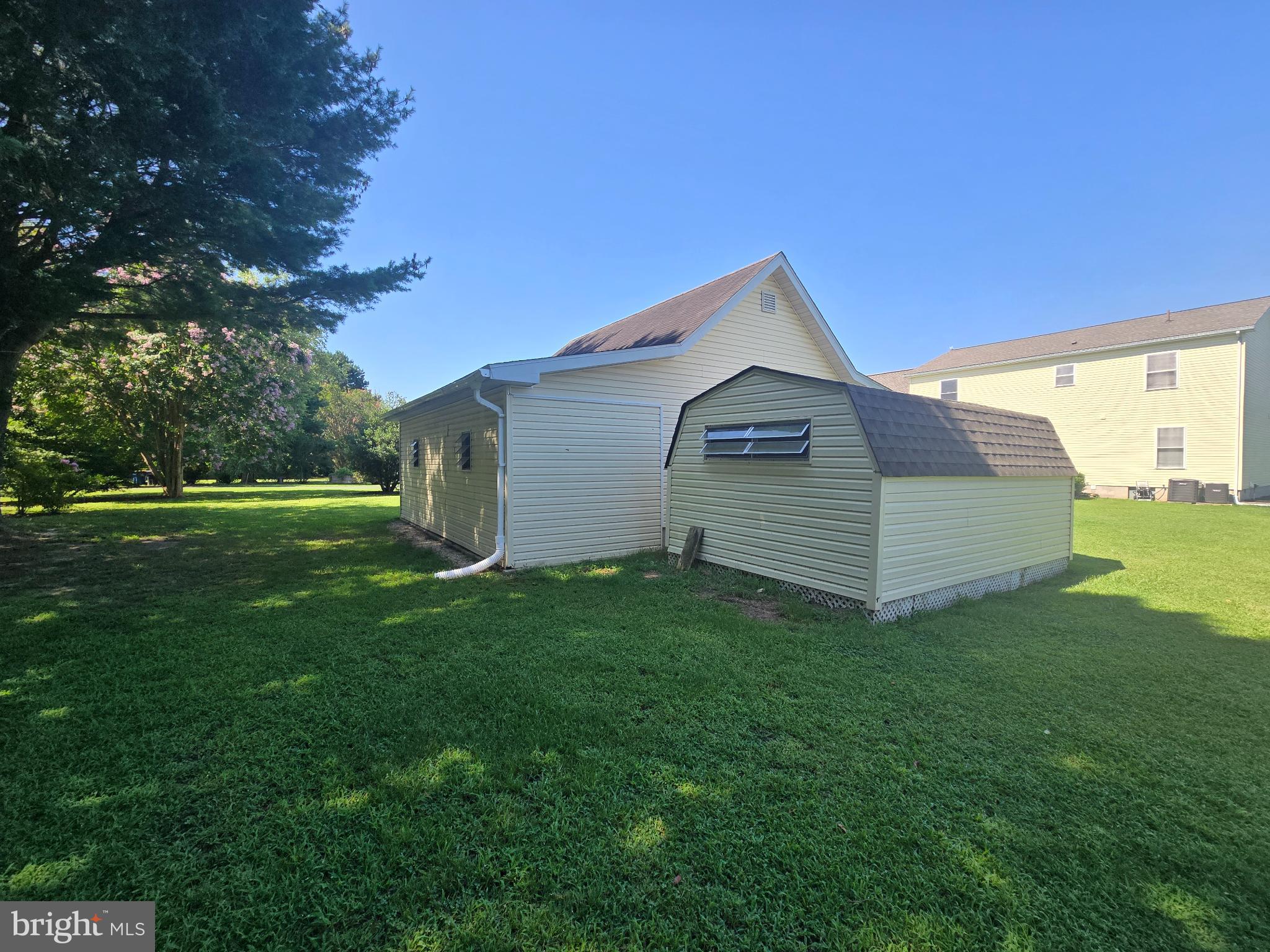 18453 Joseph Road Milton, DE 19968 - Photo 41 of 49 a view of a backyard with grass and a large tree