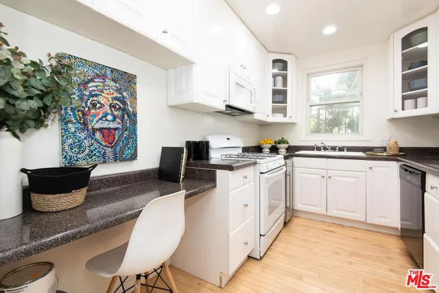 a kitchen with stainless steel appliances kitchen island granite countertop a sink and cabinets