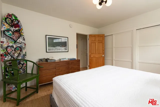 a bedroom with a bed and a dresser