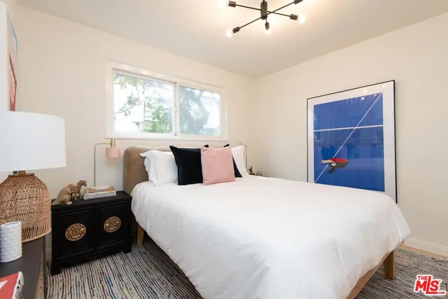 a bedroom with a bed and a tv