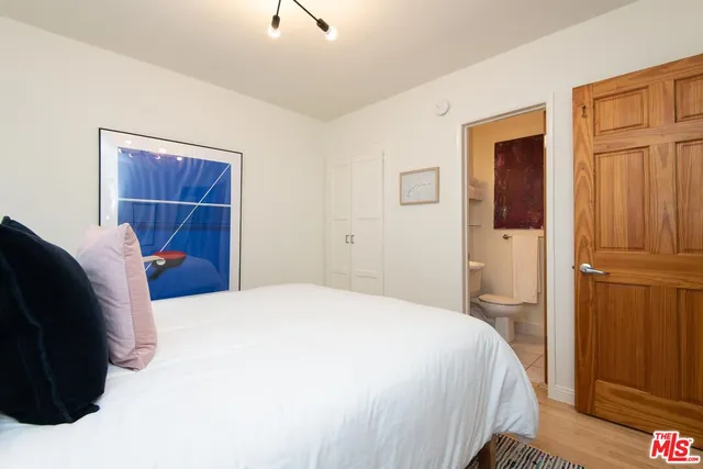 a bedroom with a bed and a closet