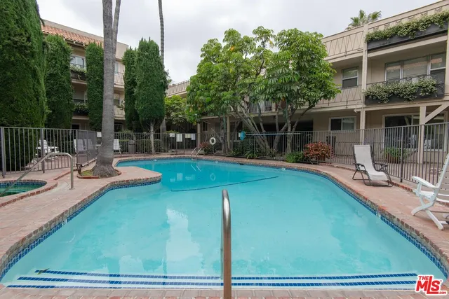 a house view with swimming pool and sitting space