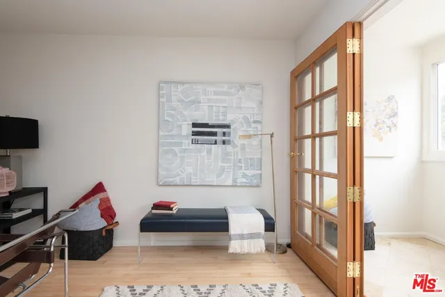 a living room with furniture a flat screen tv and a window