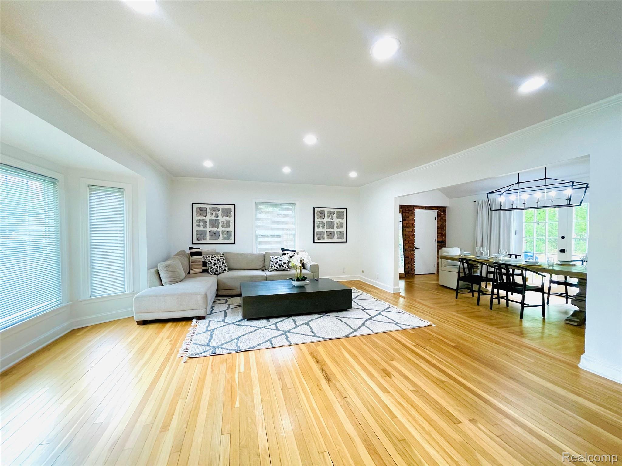 60 Devon Road Bloomfield Hills, MI 48302 - Photo 8 of 50 Expansive living area with polished wood flooring, recessed lighting, and crown molding