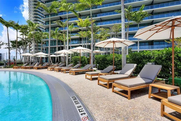 a view of a swimming pool with lounge chairs