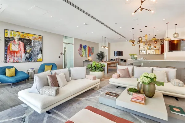 a living room filled with furniture and a chandelier