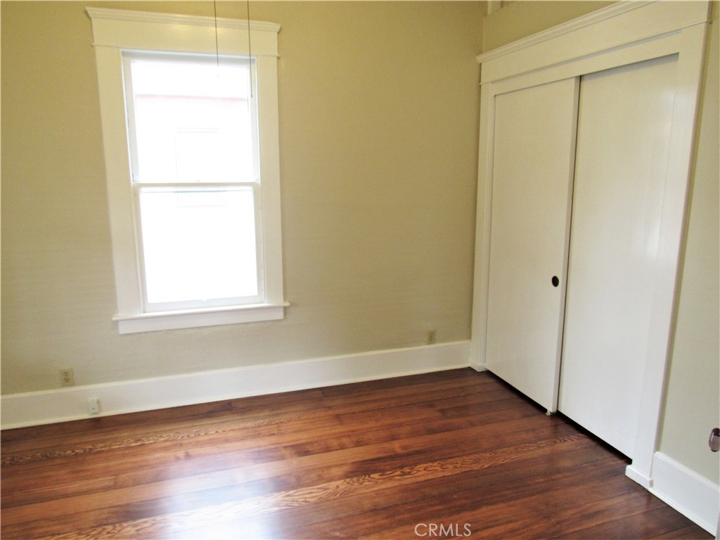478 South Grand Street Orange, CA 92866 - Photo 5 of 10 an empty room with wooden floor and a window